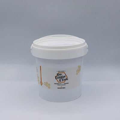 Three jars of raw honey, in different sizes, with labels displaying the brand and product name.