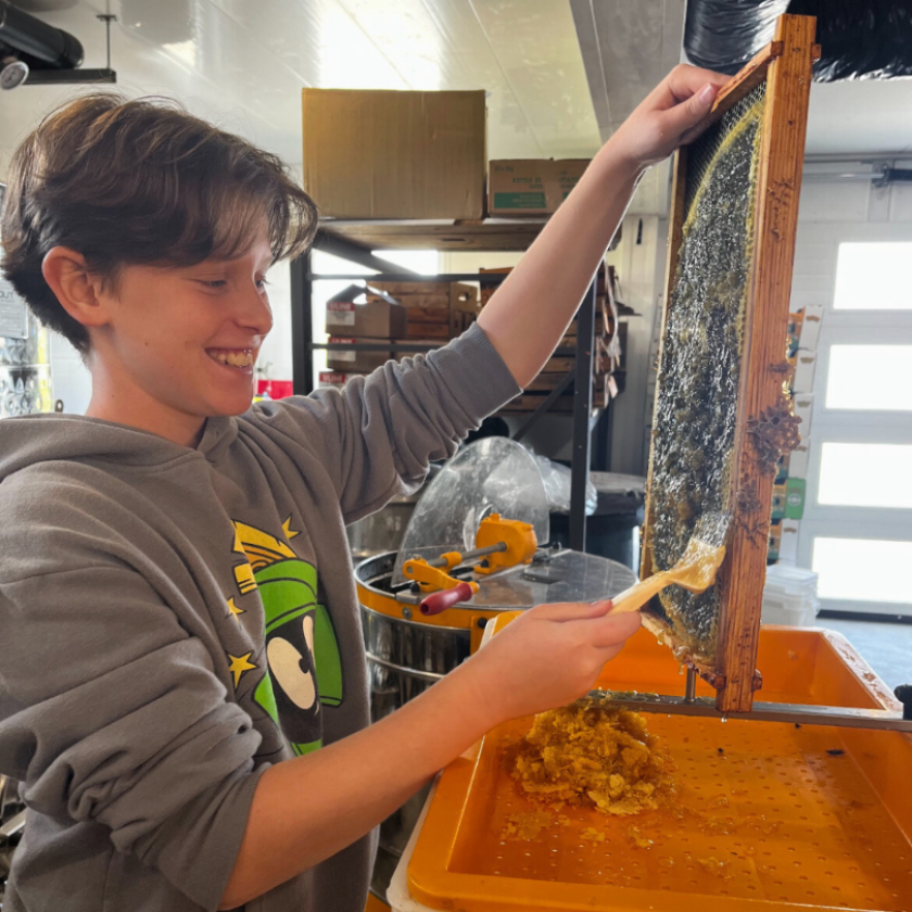 Backed By Bees Adopt a Hive program includes a hands on guided raw honey extraction for all ages.