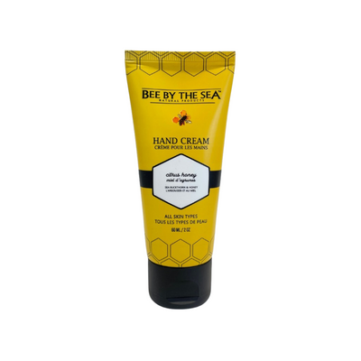 A small, yellow bottle of hand cream containing honey and other natural ingredients.