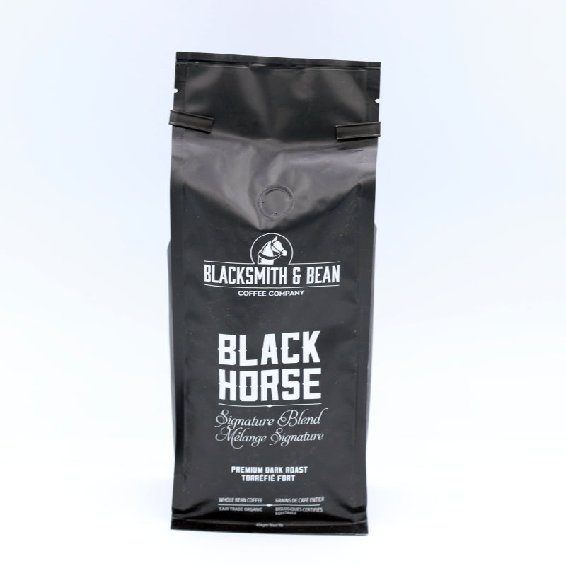 Black coffee bag labeled 'Blacksmith & Bean' on a light gray background
