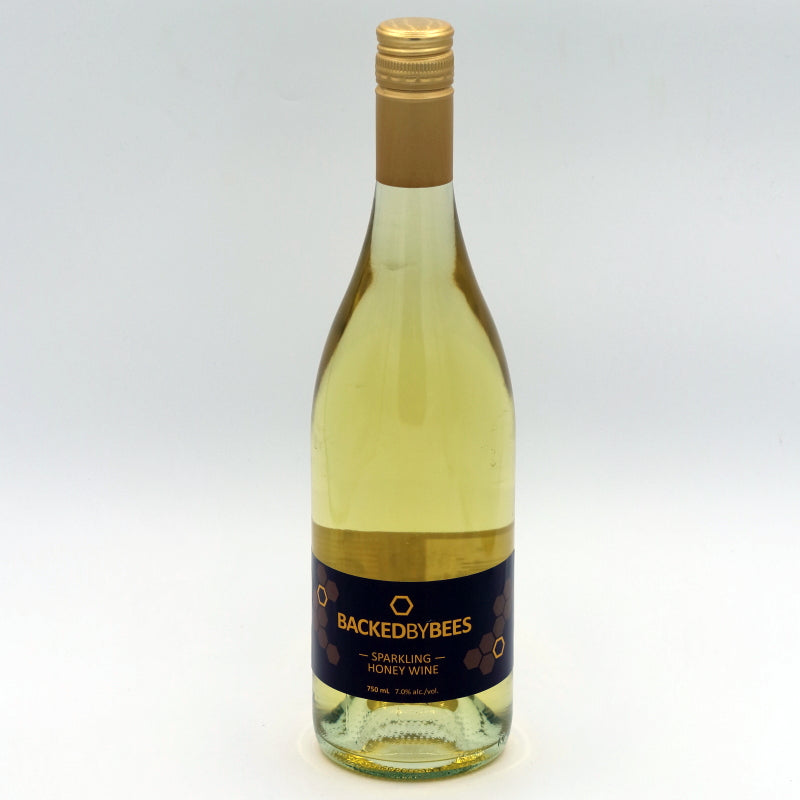 Bottle of BackedByBees sparkling honey wine on a white background